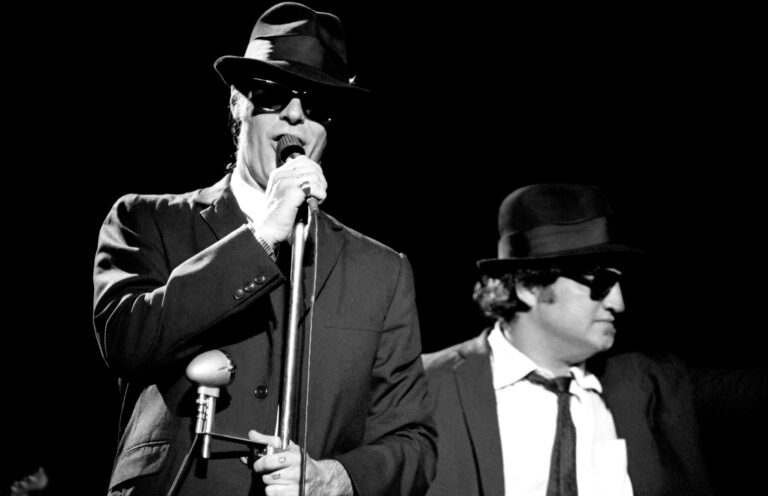 The Blues Brothers - Elwood Blues, portrayed by Canadian actor Dan Aykroyd and "Joliet" Jake Blues, portrayed by American actor John Belushi The Blues Brothers in concert, Winterland Arena, San Francisco, California, USA - 31 Dec 1978 The Blues Brothers opened for the Grateful Dead.