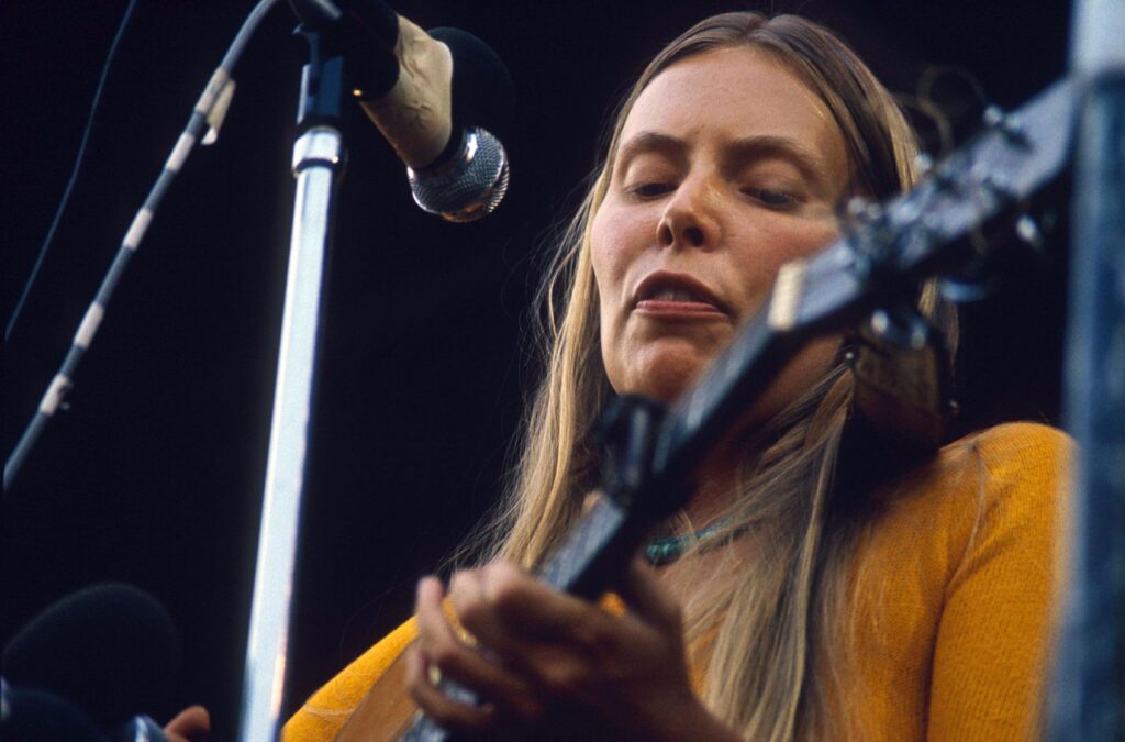 Isle of Wight Festival, Afton Down, on the western side of the Isle of Wight, England, UK - Aug 1970 Joni Mitchell - Canadian-American singer-songwriter, multi-instrumentalist, and painter Isle of Wight Festival, Afton Down, on the western side of the Isle of Wight, England, UK - Aug 1970 The Isle of Wight Festival 1970 was a music festival held between 26 and 31 August 1970 at Afton Down, an area on the western side of the Isle of Wight in England. It was the last of three consecutive music festivals to take place on the island between 1968 and 1970 and often acknowledged as the largest musical event of its time, with a larger attendance than Woodstock. Many excerpts from this festival have appeared on record and video.