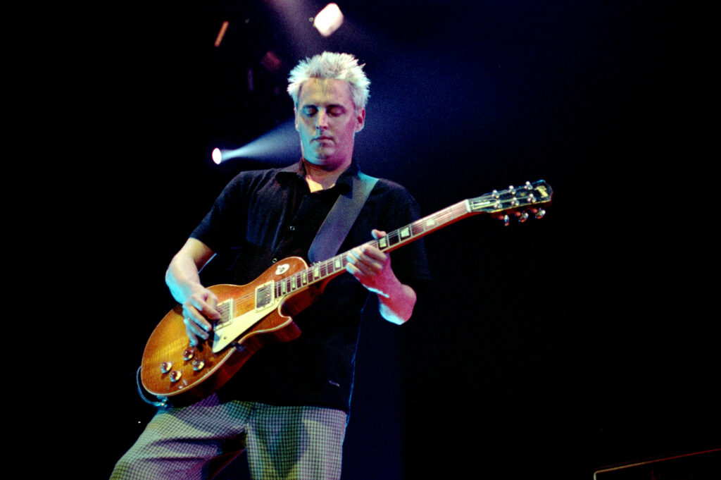 Mike McCready performing live with Pearl Jam on stage.