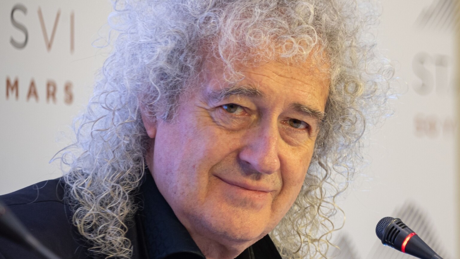 Portrait of Brian May smiling and looking into the camera, Yerevan, Armenia